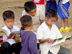 Boys reading outdoors