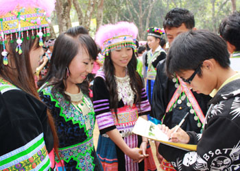 James talks with participants at the Hmong New Year festival.