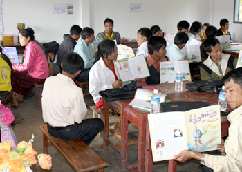 Teachers practice read-aloud skills with Big Brother Mouse, at a workshop organized by Save the Children