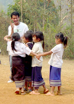 Siphone leading games at a book party in a rural Lao village