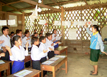 Vannaly leading a song at a Big Brother Mouse book party in Laos