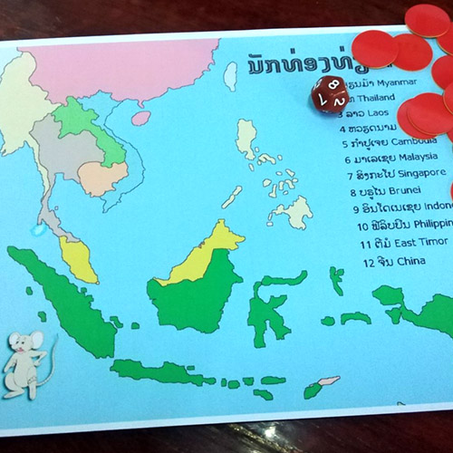 A map of Southeast Asia, counters, and a 12-sided die, for the game World Traveler