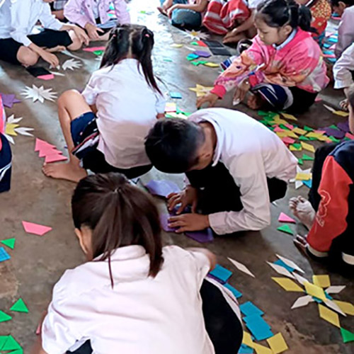 Lao schoolchildren make designs with colorful geometric shapes called pattern tiles.